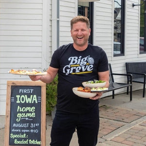 Big Grove man carrying pizza and salad