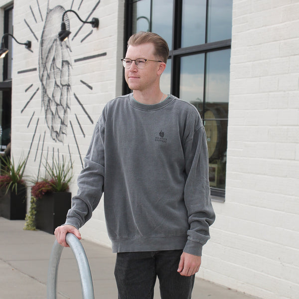 Man with glasses in gray Big Grove sweatshirt