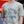 Load image into Gallery viewer, Gray-green Big Grove t-shirt with blue text on a man
