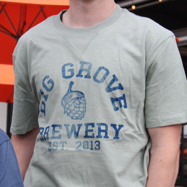 Gray-green Big Grove t-shirt with blue text on a man