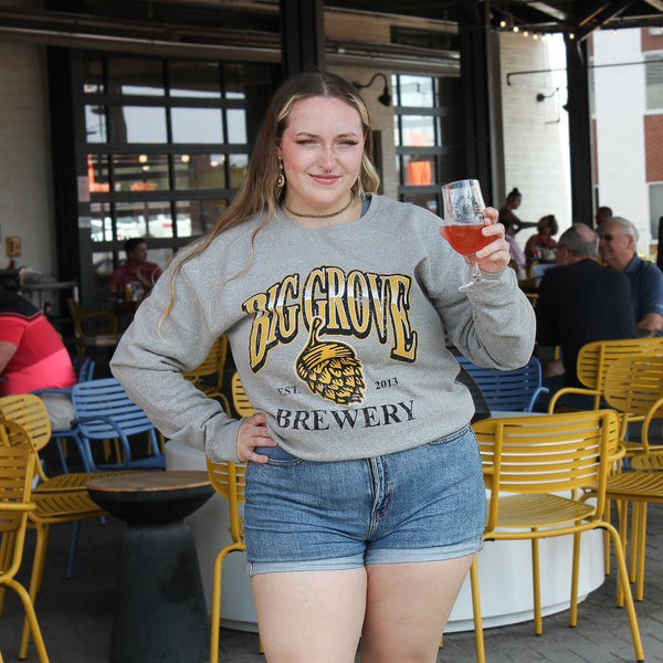 Woman with beer in Big Grove Gray 90s Gradient Athletic Crewneck