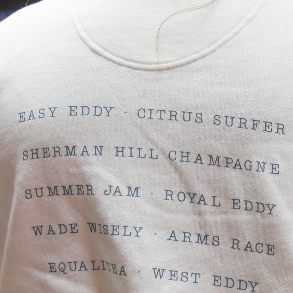 Close-up of Big Grove beer names on back of cream pullover