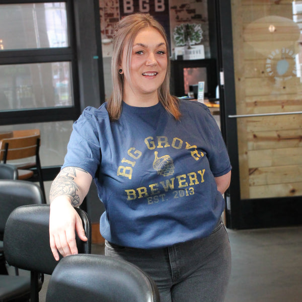 Woman wearing blue Big Grove t-shirt with yellow text